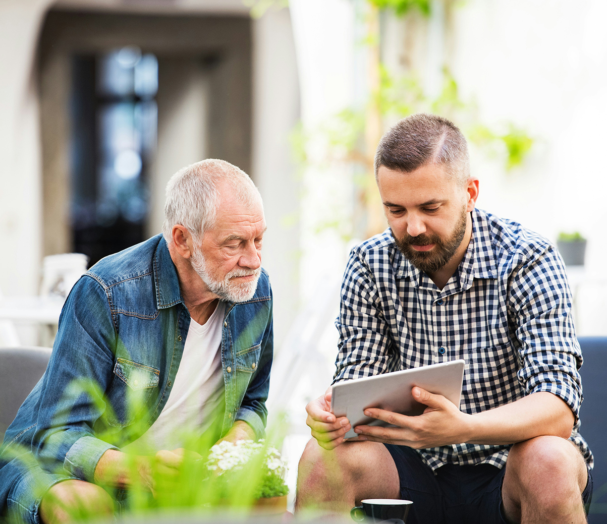 Two men looking at tablet